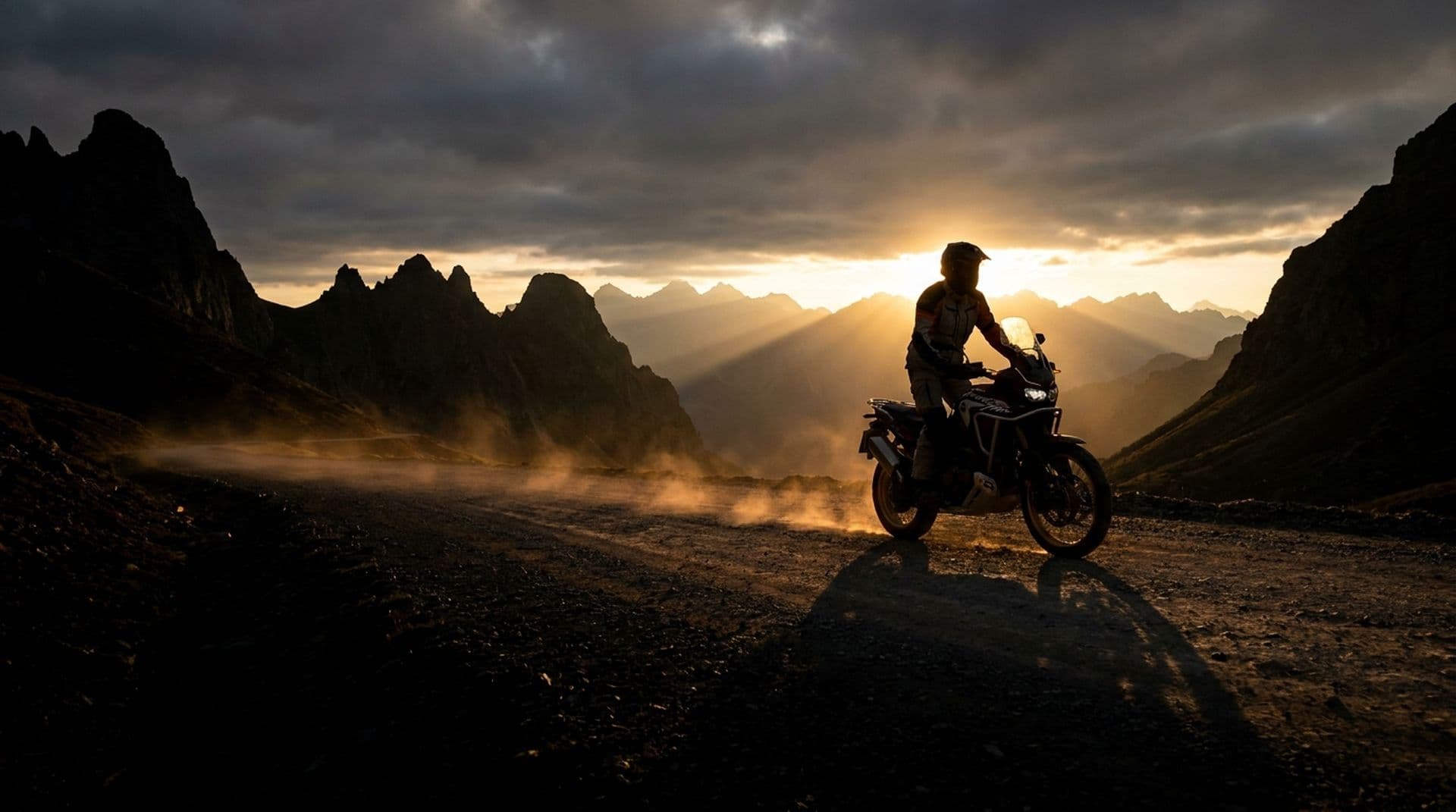 Adventure motorcycle on a mountain road at sunrise